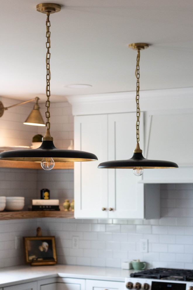 Mid-sized transitional l-shaped medium tone wood floor and brown floor open concept kitchen photo with an undermount sink, shaker cabinets, white cabinets, quartzite countertops, white backsplash, ceramic backsplash, white appliances, an island and white countertops