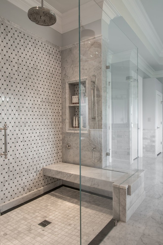Inspiration for a large traditional master bathroom in St Louis with raised-panel cabinets, white cabinets, a one-piece toilet, gray tile, white tile, stone slab, grey walls, porcelain floors, a drop-in sink, a claw-foot tub, a curbless shower and marble benchtops.