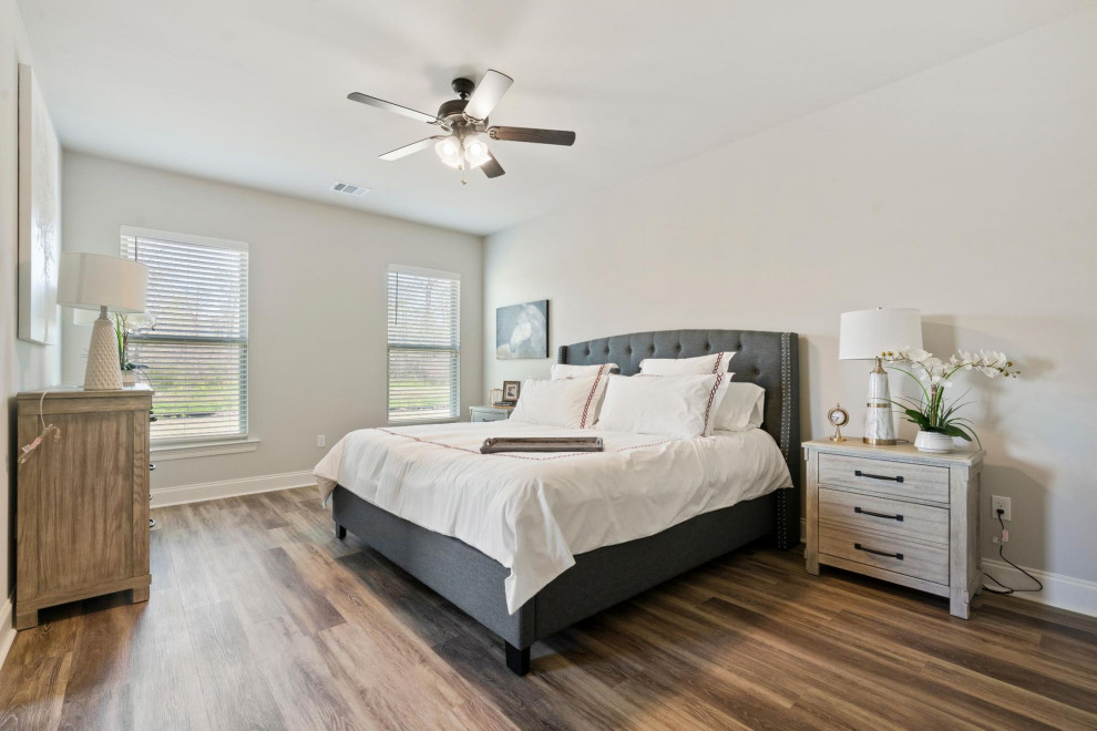 Design ideas for a mid-sized traditional master bedroom in Other with grey walls, medium hardwood floors and brown floor.