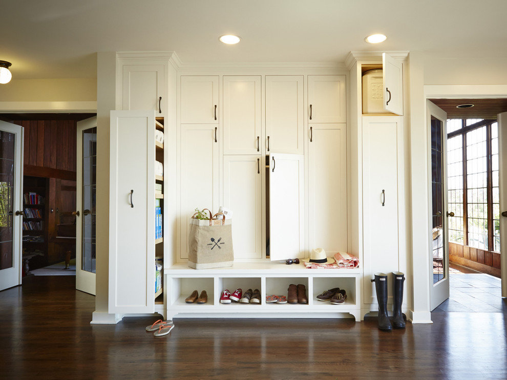 Design ideas for a traditional mudroom in Seattle with beige walls and dark hardwood floors.
