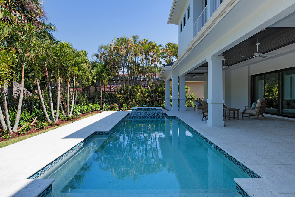 Mid-sized transitional backyard concrete paver and rectangular lap hot tub photo in Miami