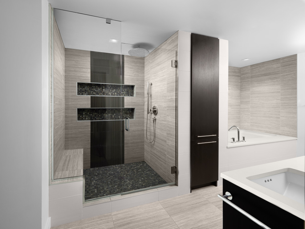 Design ideas for a mid-sized contemporary master bathroom in Portland with flat-panel cabinets, dark wood cabinets, an undermount tub, an alcove shower, a two-piece toilet, gray tile, porcelain tile, grey walls, porcelain floors, an undermount sink, engineered quartz benchtops, grey floor, a hinged shower door and white benchtops.