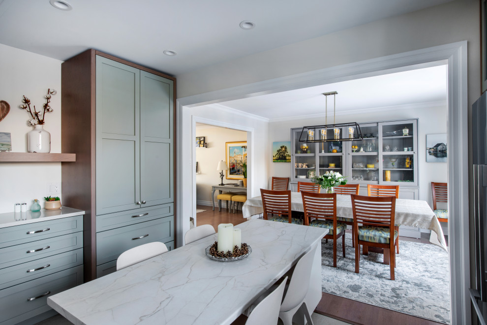 Eat-in kitchen - mid-sized transitional u-shaped linoleum floor and gray floor eat-in kitchen idea in Ottawa with a farmhouse sink, shaker cabinets, gray cabinets, quartz countertops, white backsplash, subway tile backsplash, stainless steel appliances, an island and white countertops