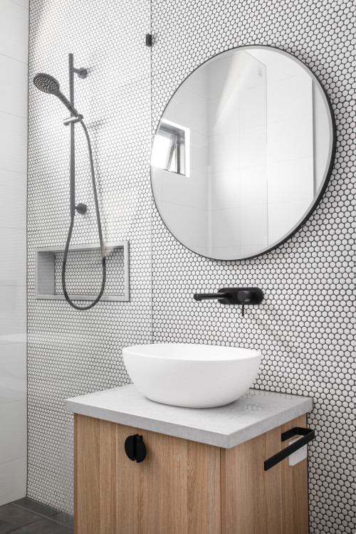 Wood Vanity and White Countertops with Hexagon Wall Tiles
