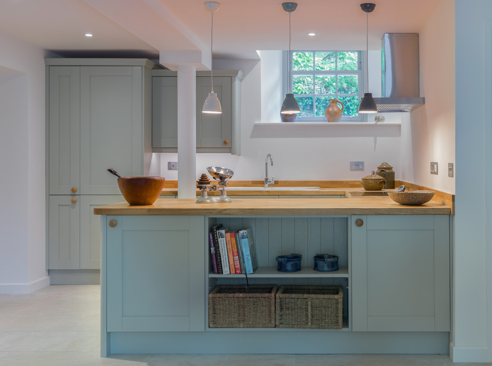 Small transitional u-shaped kitchen in Devon with an undermount sink, recessed-panel cabinets, grey cabinets, wood benchtops, no island, grey floor and beige benchtop.