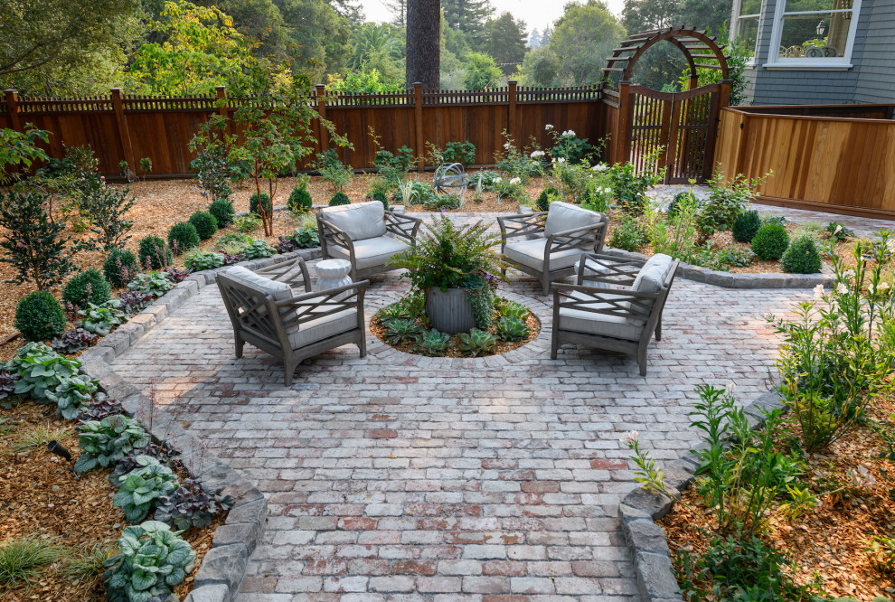 Expansive traditional back patio in San Francisco with brick paving.