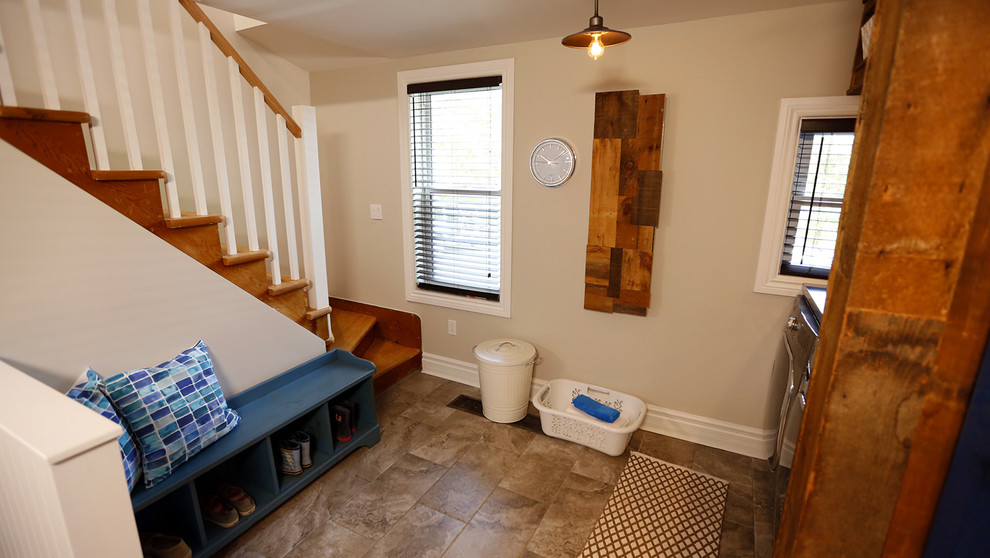 Inspiration for a small transitional ceramic tile mudroom remodel in Toronto with beige walls