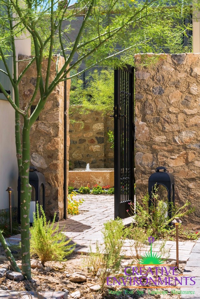 Pool fountain - mid-sized rustic backyard decomposed granite and rectangular pool fountain idea in Phoenix