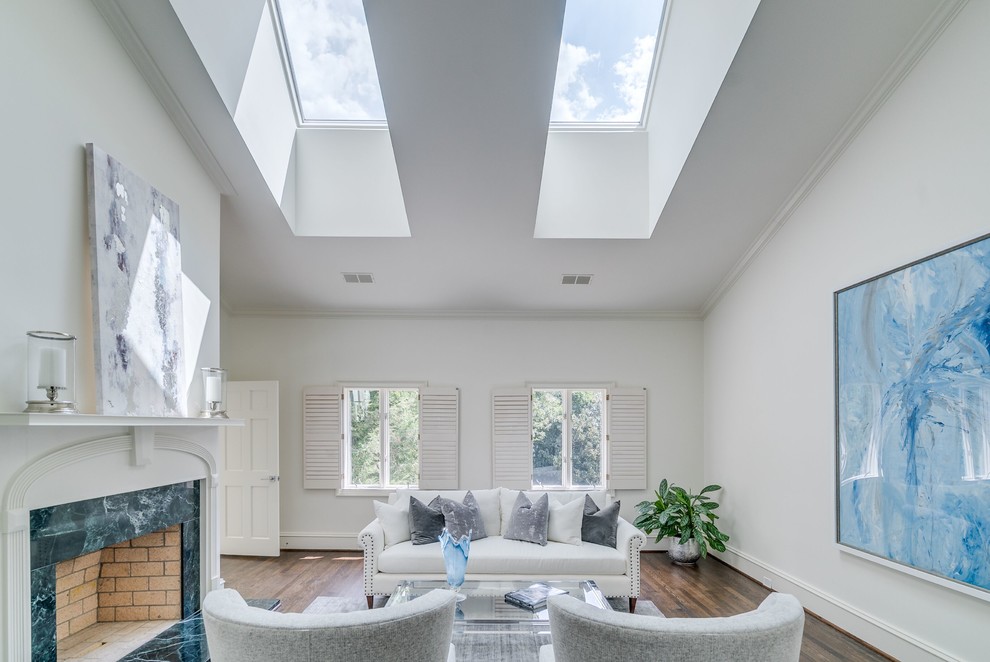 This is an example of an expansive traditional master bedroom in Atlanta with white walls, medium hardwood floors, a standard fireplace, a brick fireplace surround and brown floor.