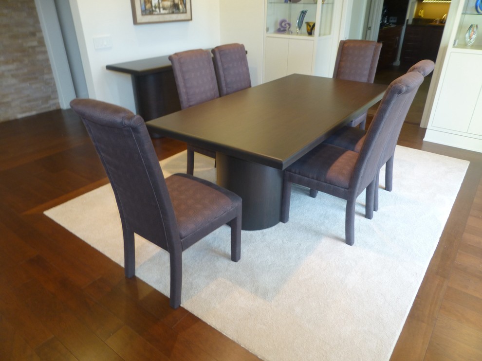 Example of a mid-sized transitional medium tone wood floor and brown floor enclosed dining room design in Chicago with white walls and no fireplace