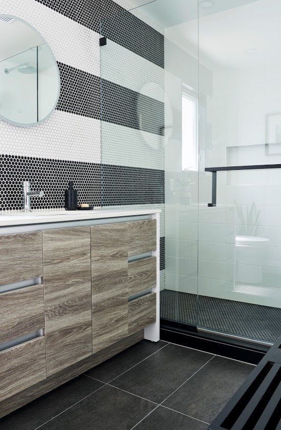 Inspiration for a modern bathroom in Toronto with light wood cabinets, black and white tile and white benchtops.