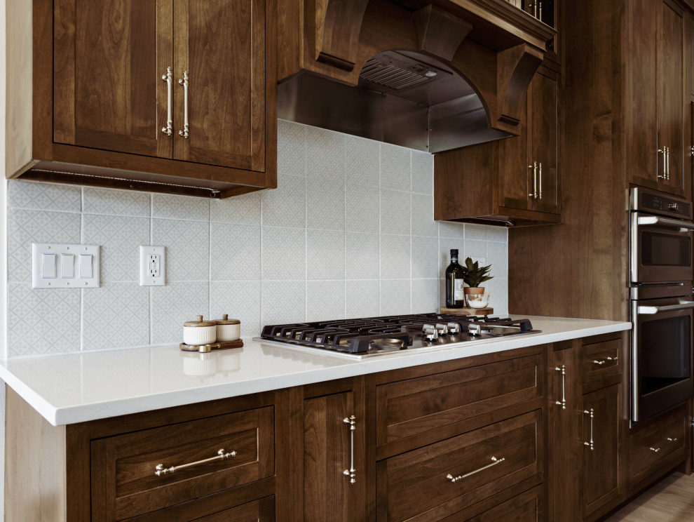 Open concept kitchen - transitional open concept kitchen idea with shaker cabinets, medium tone wood cabinets, quartz countertops, white backsplash, ceramic backsplash, an island and white countertops