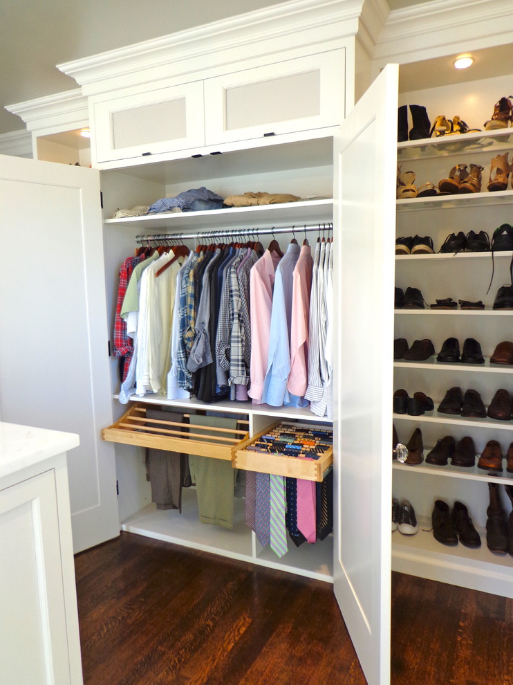 This is an example of a large contemporary gender-neutral walk-in wardrobe in Newark with open cabinets, white cabinets and dark hardwood floors.