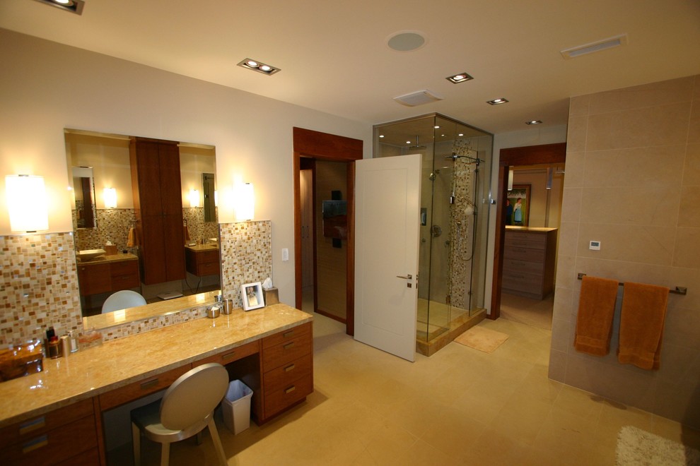 Example of a large transitional master beige tile and pebble tile porcelain tile and beige floor drop-in bathtub design in Toronto with beige walls, flat-panel cabinets, dark wood cabinets, a vessel sink, quartzite countertops, a hinged shower door and beige countertops