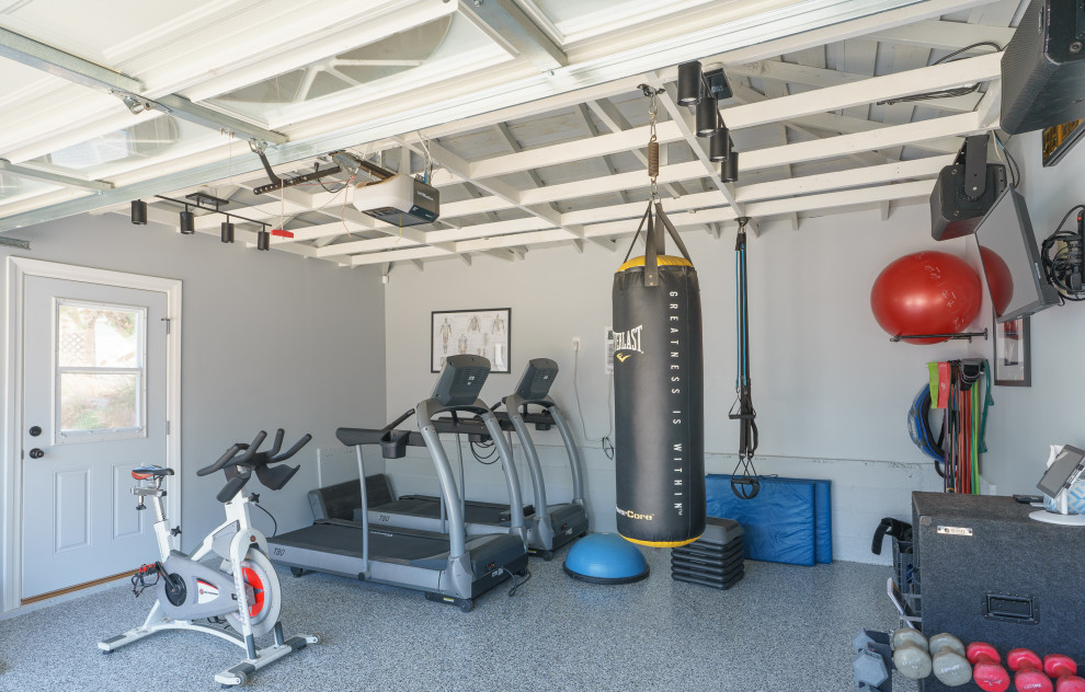 This is an example of a medium sized modern home gym in Los Angeles with grey walls, concrete flooring, multi-coloured floors and exposed beams.