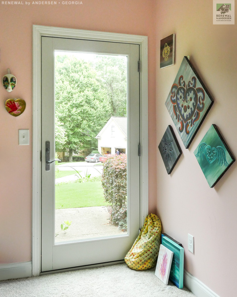 Photo of a mid-sized entryway in Atlanta with carpet, a single front door, a white front door, grey floor, vaulted and pink walls.