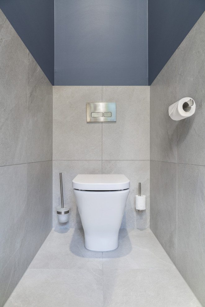 Mid-sized contemporary bathroom in Melbourne with light wood cabinets, a corner shower, gray tile, porcelain tile, blue walls, porcelain floors, a console sink, engineered quartz benchtops, grey floor and white benchtops.