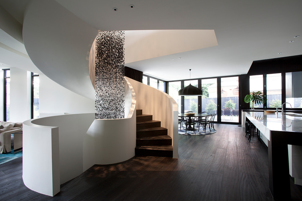 Inspiration for a contemporary wood curved staircase with wood risers.