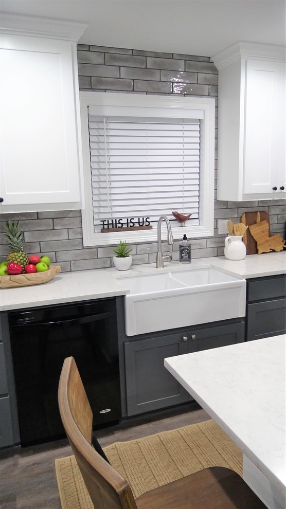 Photo of a small country l-shaped open plan kitchen in Other with a farmhouse sink, shaker cabinets, white cabinets, quartzite benchtops, grey splashback, subway tile splashback, vinyl floors, with island, grey floor and white benchtop.