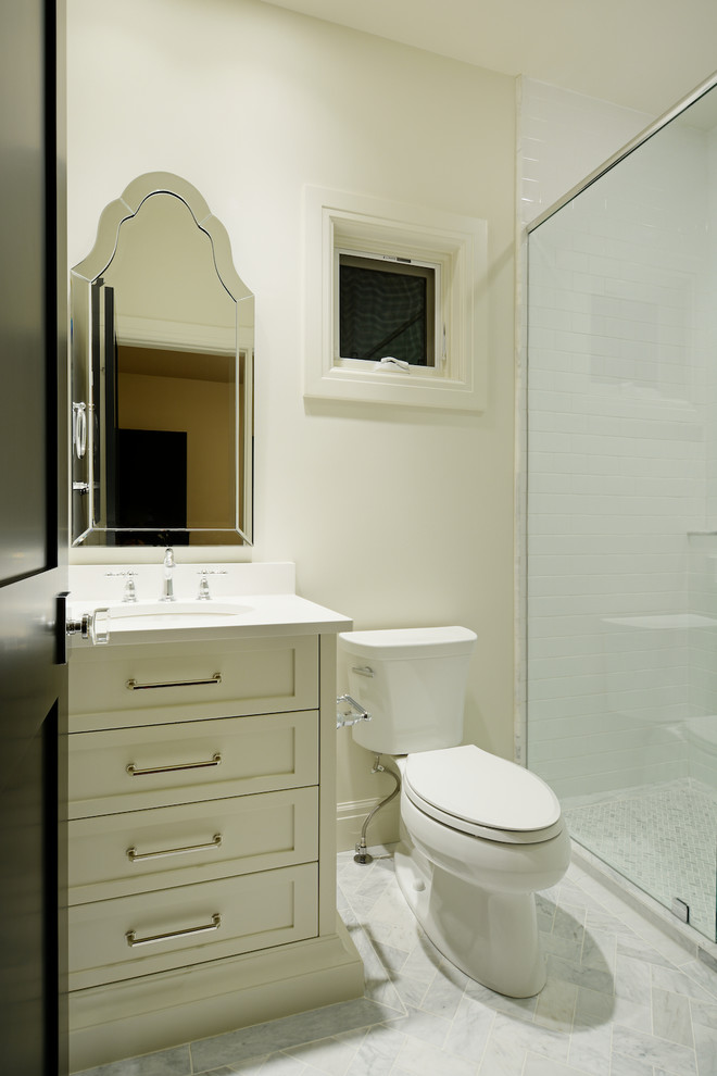 Inspiration for a transitional bathroom in Calgary with marble benchtops, a freestanding tub and dark hardwood floors.