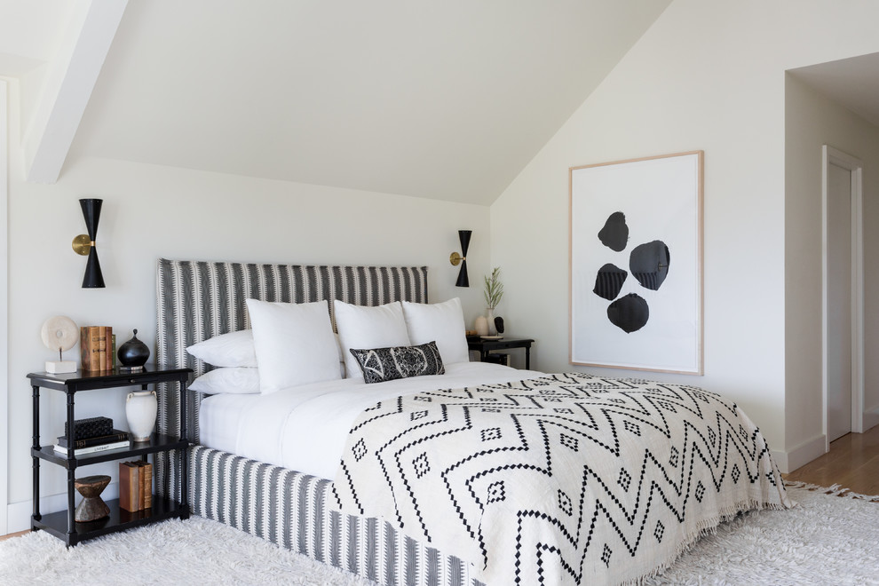Transitional bedroom in Los Angeles with white walls and light hardwood floors.