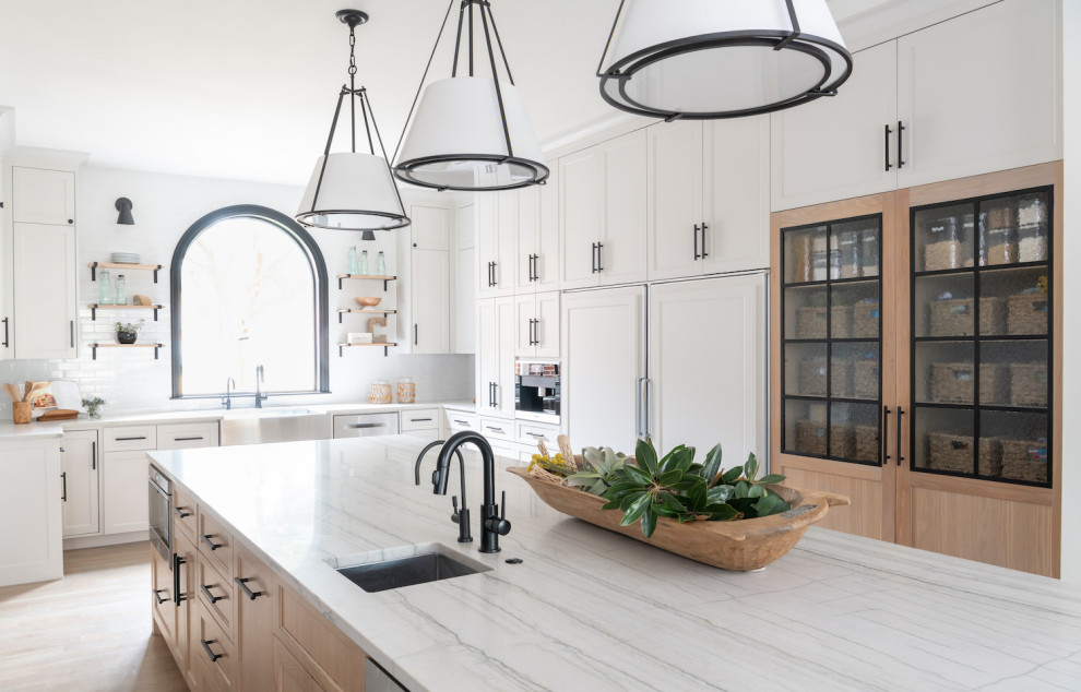 Photo of a large scandinavian u-shaped eat-in kitchen in Dallas with an undermount sink, beaded inset cabinets, light wood cabinets, marble benchtops, white splashback, ceramic splashback, stainless steel appliances, light hardwood floors, with island, white floor and white benchtop.