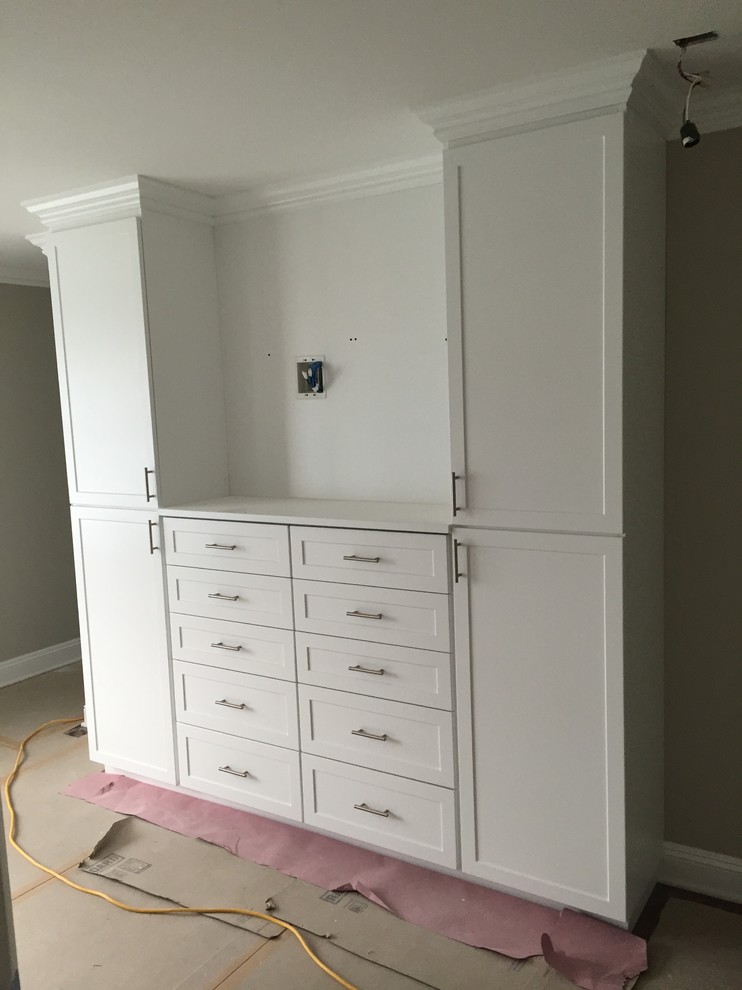 Mid-sized arts and crafts master bedroom in New York with beige walls and medium hardwood floors.