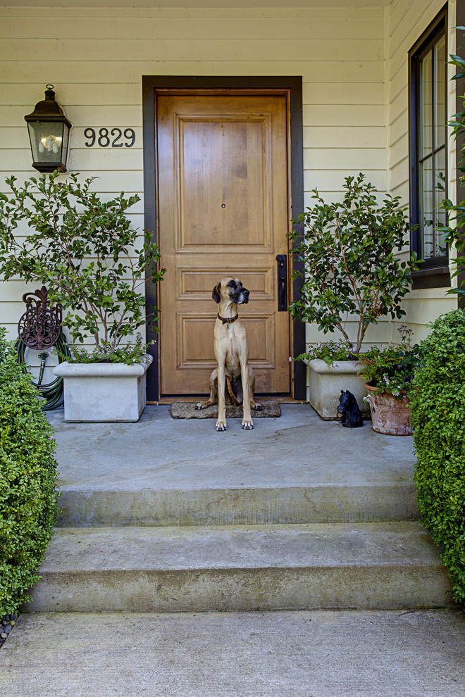 This is an example of a traditional front door in Seattle with a single front door and a medium wood front door.
