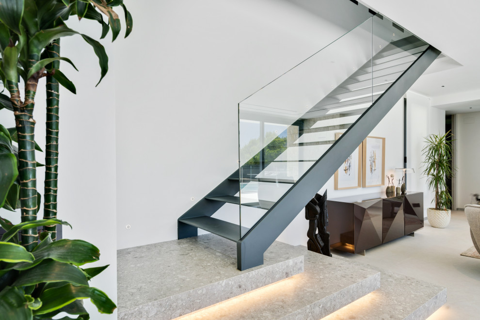 Design ideas for a mid-sized contemporary metal straight staircase in Alicante-Costa Blanca with open risers and glass railing.