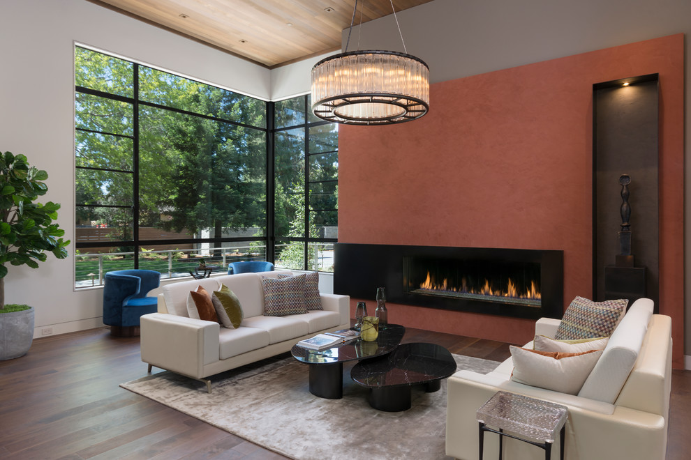 Inspiration for a contemporary open concept living room in Orange County with white walls, dark hardwood floors, a ribbon fireplace and brown floor.