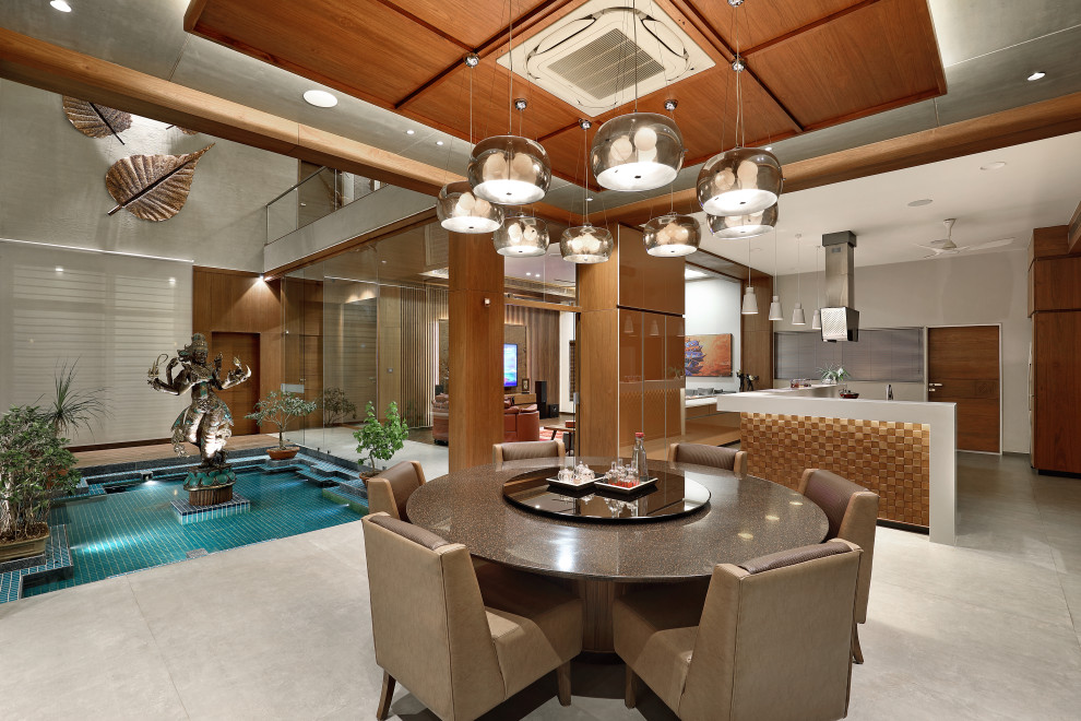 This is an example of a contemporary dining room in Ahmedabad.