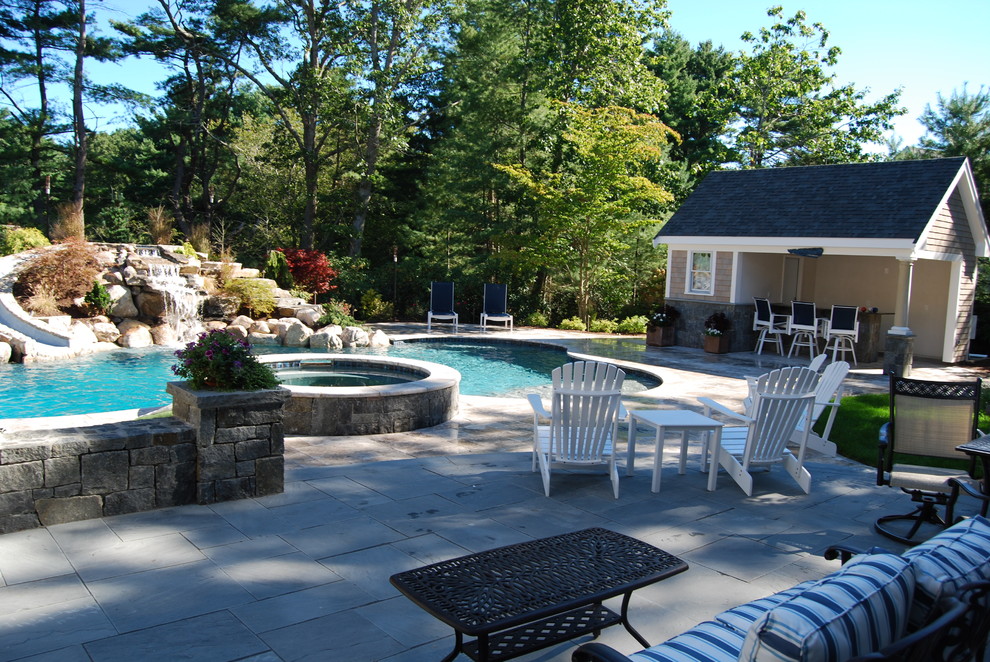 Water slide - mid-sized rustic backyard stone and kidney-shaped natural water slide idea in Boston