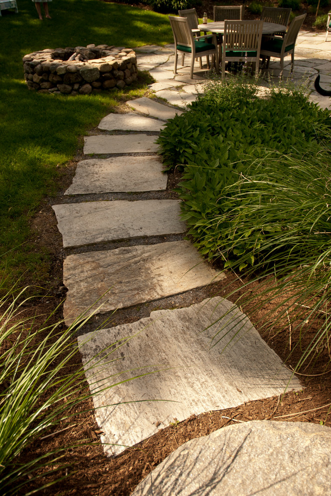 This is an example of a traditional landscaping in New York with a fire pit.