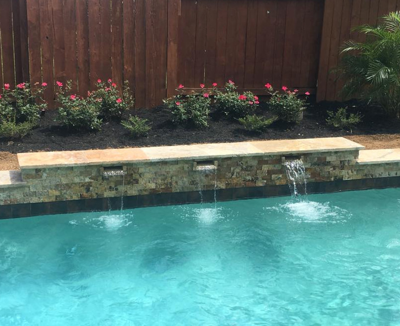 Photo of a mid-sized transitional backyard rectangular natural pool in Orange County with a hot tub and concrete pavers.