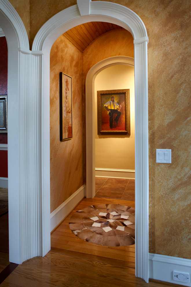 Mid-sized transitional medium tone wood floor hallway photo with beige walls