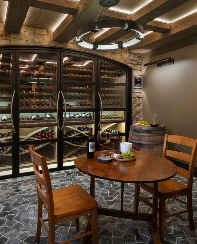 Design ideas for a large arts and crafts wine cellar in Denver with terra-cotta floors, display racks and black floor.