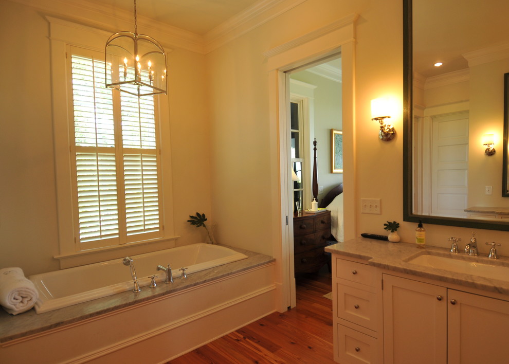 Photo of a traditional bathroom in Charleston with an undermount sink, shaker cabinets, white cabinets and a drop-in tub.