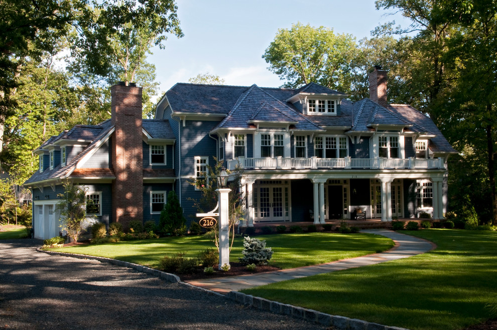 Photo of an expansive traditional two-storey blue house exterior in New York with mixed siding, a shingle roof, shingle siding and a black roof.