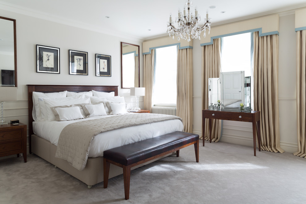 Inspiration for a mid-sized traditional master bedroom in London with white walls, carpet, no fireplace and grey floor.