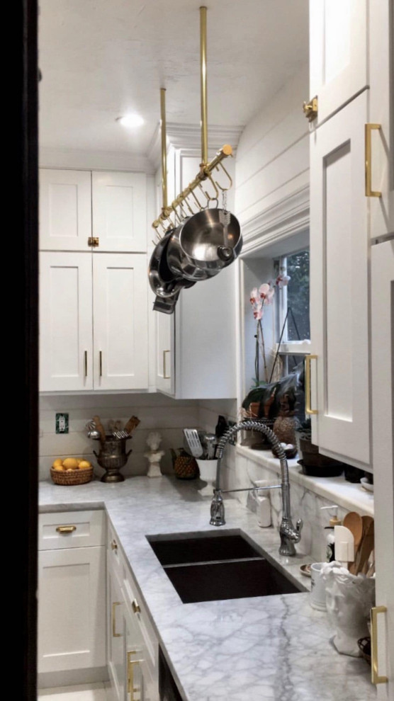 Small transitional painted wood floor and white floor enclosed kitchen photo with an undermount sink, shaker cabinets, white cabinets, marble countertops, white backsplash, shiplap backsplash, stainless steel appliances, no island and white countertops