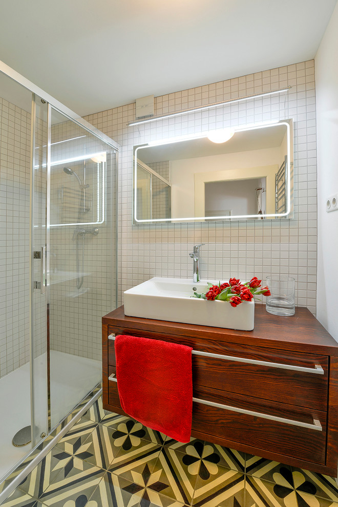 This is an example of a small traditional bathroom in Other with a vessel sink, flat-panel cabinets, dark wood cabinets, laminate benchtops, a curbless shower, white tile, ceramic tile, white walls and ceramic floors.