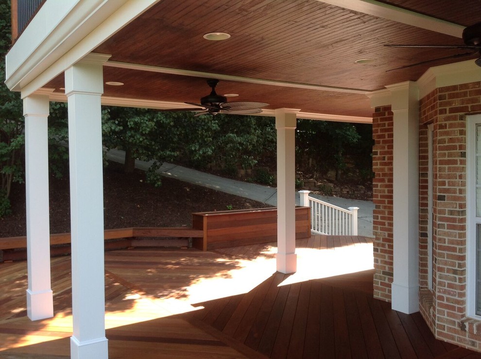 Photo of a large industrial front yard verandah in Atlanta with a container garden, decking and a roof extension.