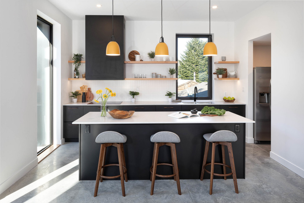 Design ideas for a beach style galley eat-in kitchen in Other with an undermount sink, flat-panel cabinets, black cabinets, recycled glass benchtops, white splashback, cement tile splashback, panelled appliances, ceramic floors, with island, grey floor and white benchtop.