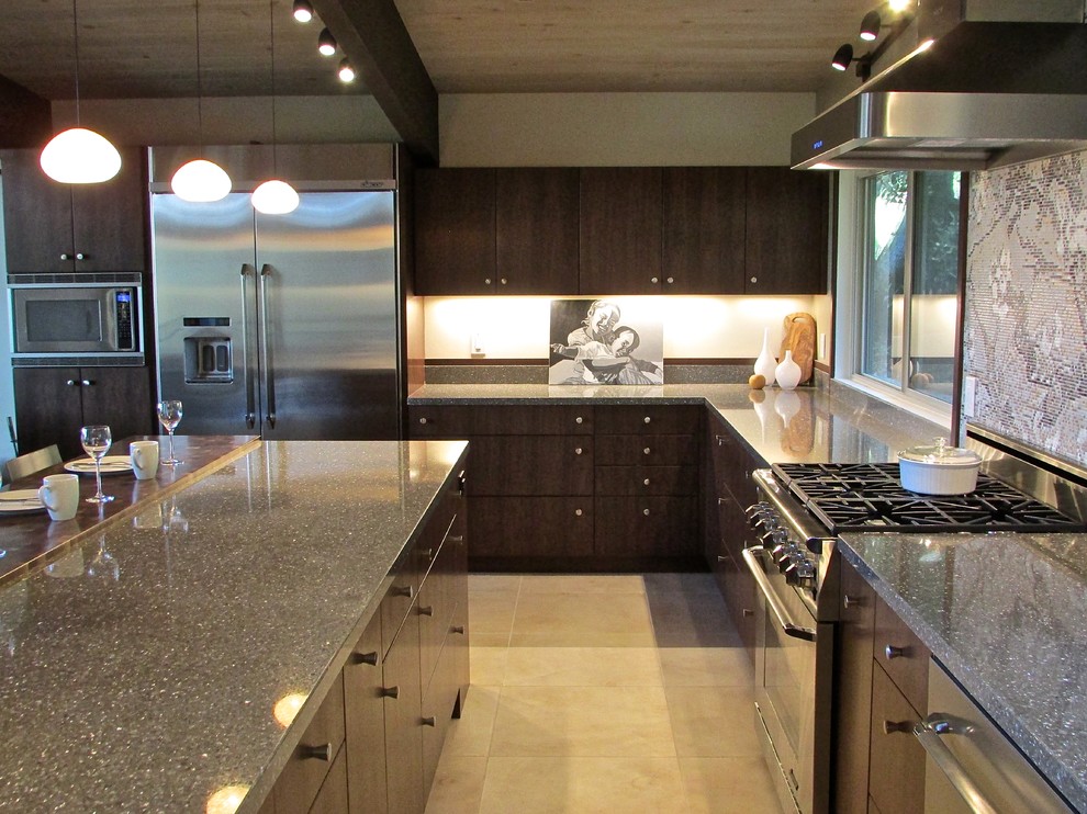 Photo of a large midcentury u-shaped open plan kitchen in San Francisco with an undermount sink, flat-panel cabinets, dark wood cabinets, quartz benchtops, multi-coloured splashback, mosaic tile splashback, stainless steel appliances, porcelain floors and with island.