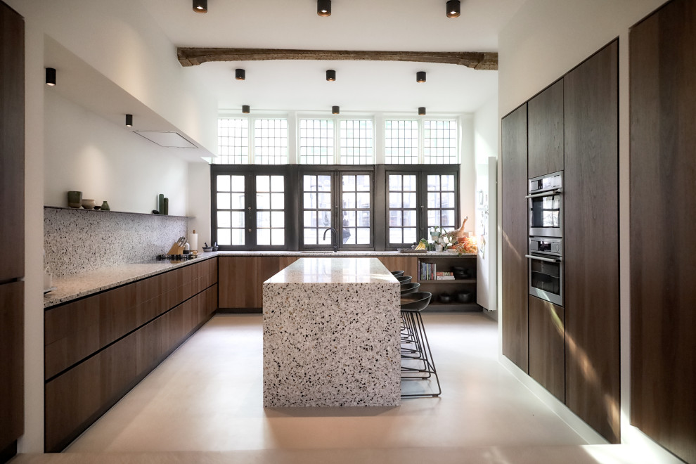 Inspiration for a large modern single-wall separate kitchen with flat-panel cabinets, brown cabinets, granite benchtops, grey splashback, concrete floors, with island, grey floor, grey benchtop and exposed beam.