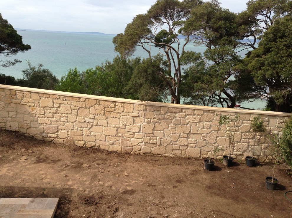 Inspiration for a country exterior in Melbourne with stone veneer.