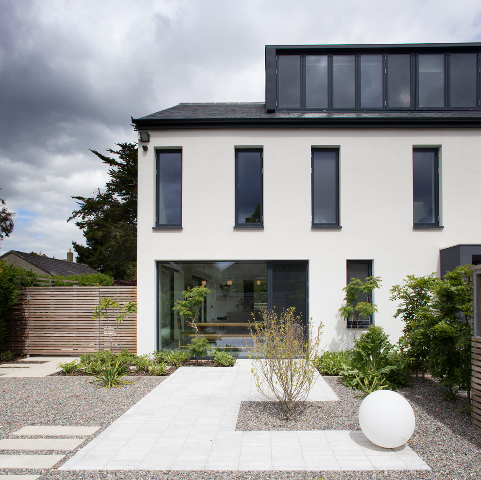 Photo of a large contemporary courtyard full sun formal garden for summer in Dublin with natural stone pavers.