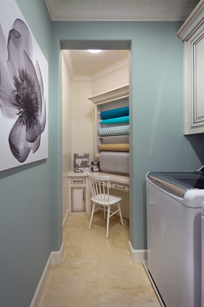 Photo of an expansive utility room in Orange County with grey walls, ceramic floors, a stacked washer and dryer and beige cabinets.