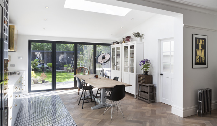 This is an example of a mid-sized contemporary kitchen/dining combo in London with medium hardwood floors.