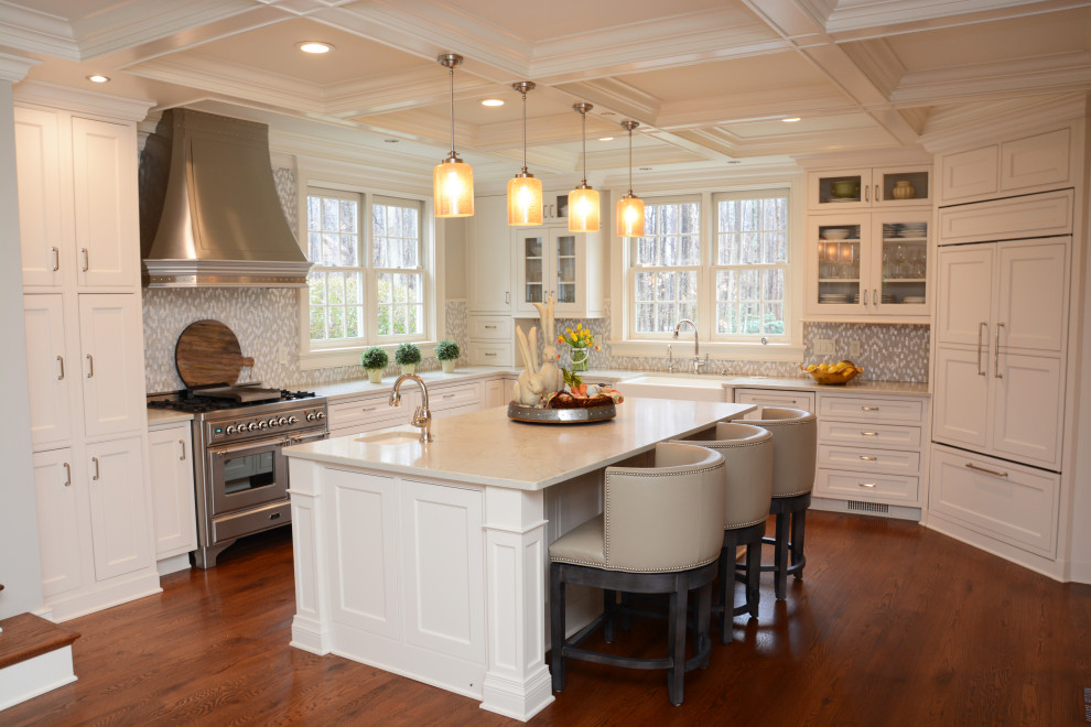 Inspiration for a large traditional u-shaped separate kitchen in Baltimore with a farmhouse sink, white cabinets, quartz benchtops, grey splashback, panelled appliances, dark hardwood floors, with island, brown floor, white benchtop, coffered, shaker cabinets and mosaic tile splashback.